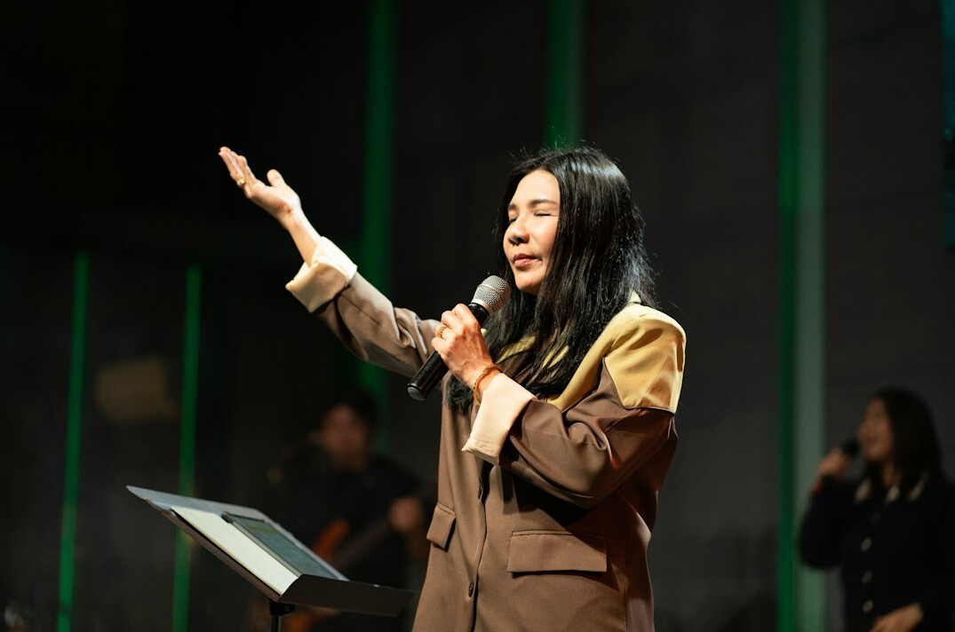 woman speaking confidently on stage