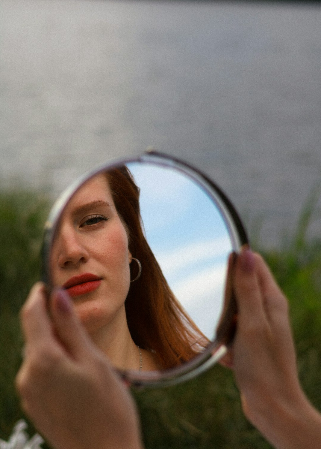 person looking in mirror thinking