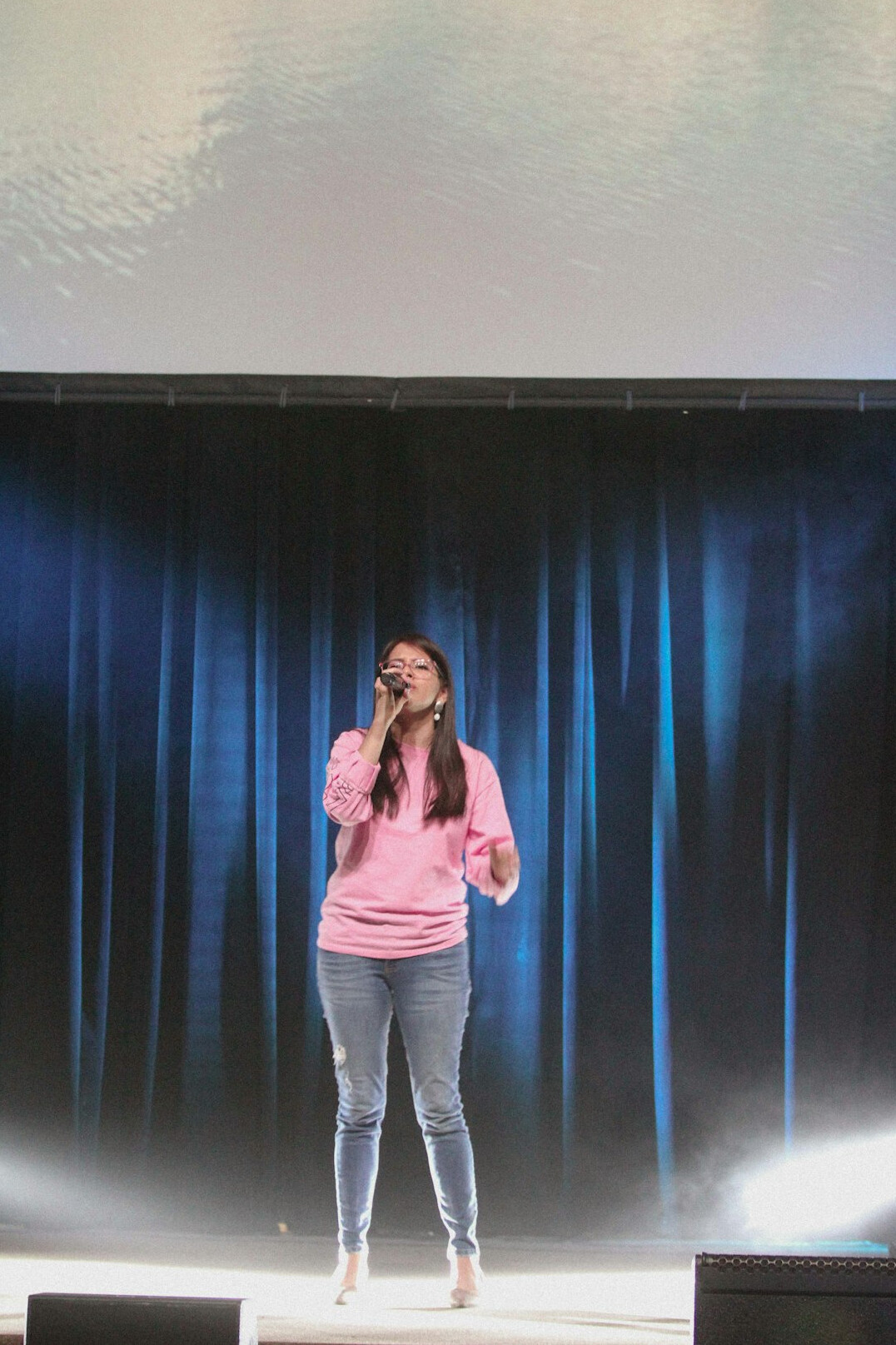 woman speaking confidently on stage