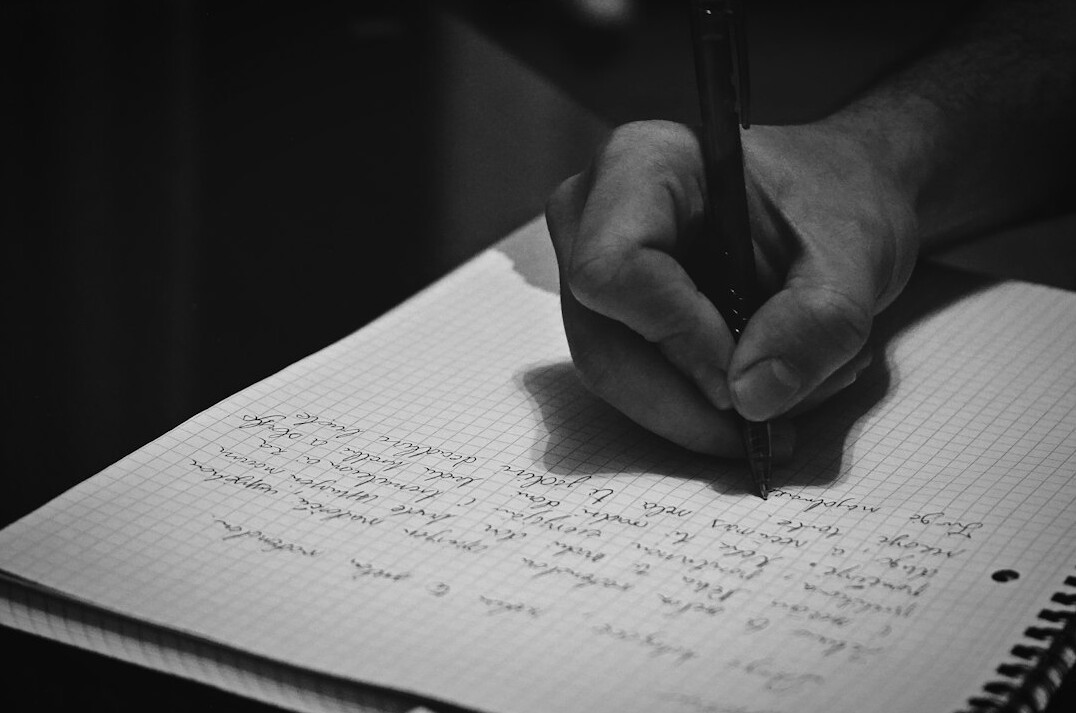 person writing notes on communication